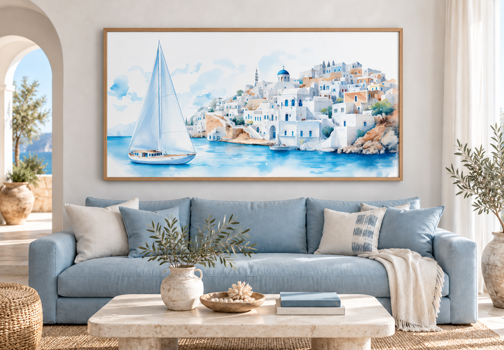 Santorini Sea and Sailboat Framed Canvas Wall Art above a blue sofa in a coastal living room.