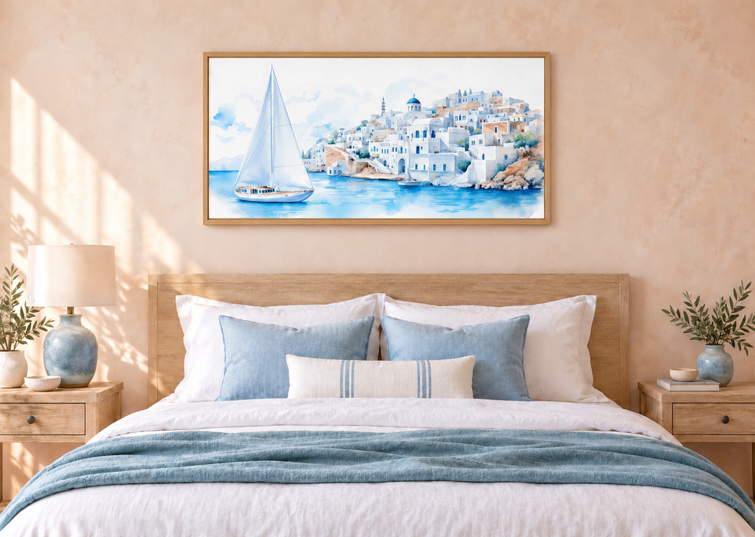 Santorini Sea and Sailboat Framed Canvas Wall Art above a bed in a coastal-style bedroom.