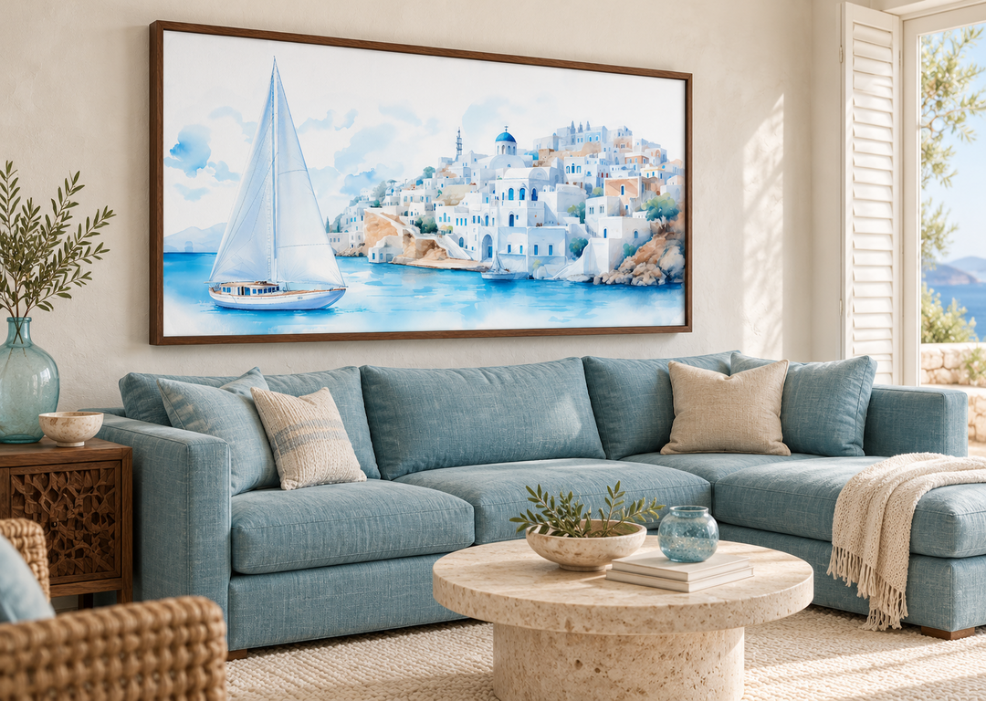 Santorini Sea and Sailboat Framed Canvas Wall Art above a blue sectional sofa in a living room.