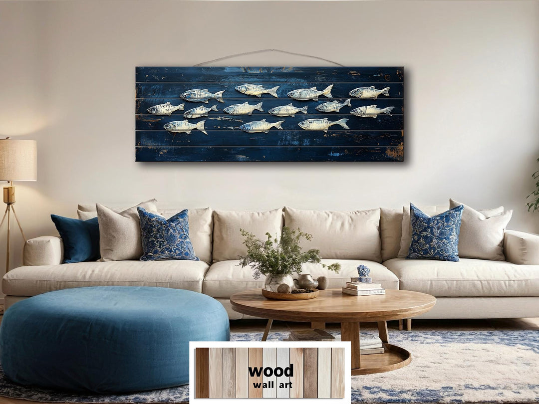 A long, narrow distressed wood wall art piece featuring a school of fish on a deep blue background.