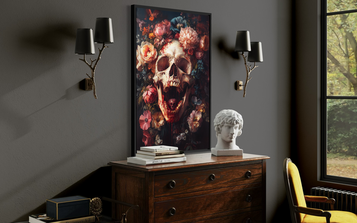 a dark room with a large floral painting hanging on the wall, a wooden dresser with a bust and books, and a yellow armchair.