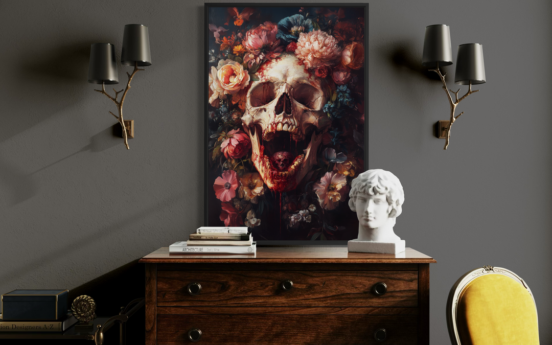 a wooden dresser with a white bust of a person's head on top, a stack of books, and a framed artwork of a skull with flowers on the wall above the dresser.