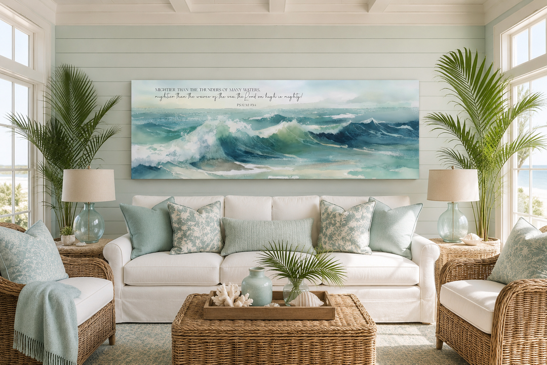 Panoramic ocean wave canvas art with Psalm 93:4 scripture above a white sofa in a coastal room.