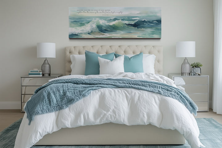 Mightier Than The Waves horizontal framed canvas wall art with Psalm 93:4 over a bed.