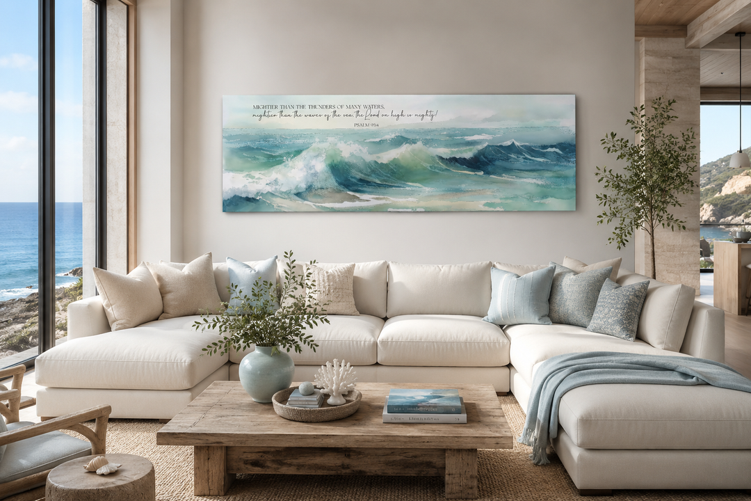 Horizontal framed canvas wall art featuring ocean waves and Psalm 93:4 scripture above a white sofa.