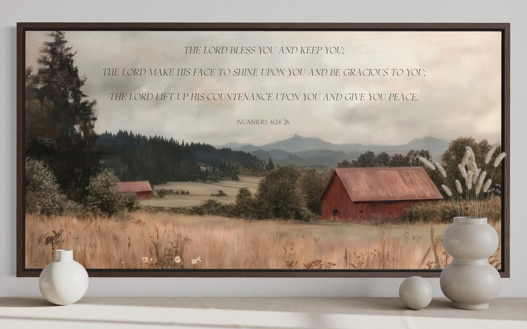 Framed landscape wall art of a red barn and field with the scripture Numbers 6:24-26.