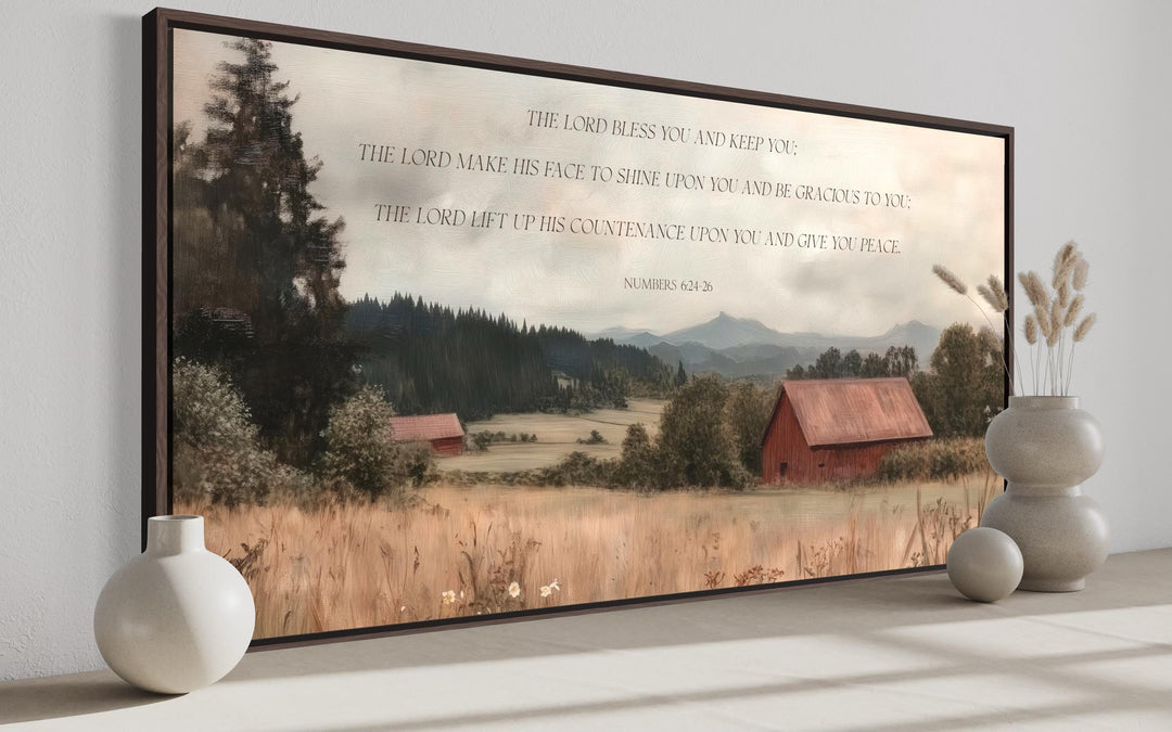 Framed landscape wall art of a red barn and field with the scripture Numbers 6:24-26.