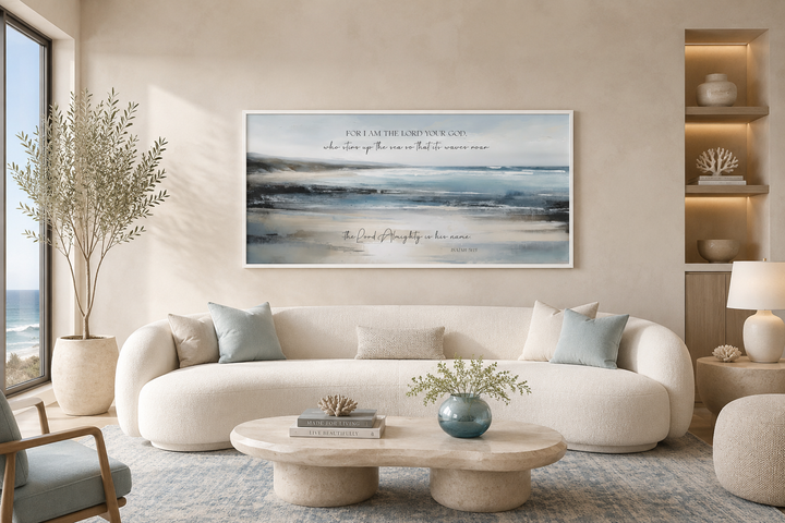 Coastal canvas wall art with Isaiah 51:15 scripture above a white sofa in a serene living room.