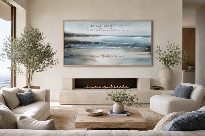 Coastal canvas wall art with Isaiah 51:15 scripture above a modern fireplace in a neutral room.