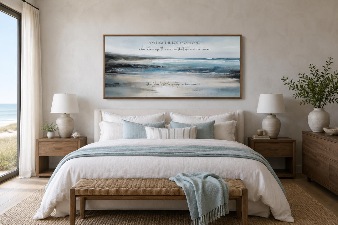 Coastal canvas wall art with Isaiah 51:15 scripture above a bed in a serene, neutral bedroom.