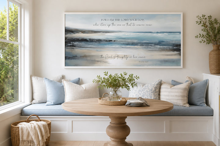 Coastal canvas wall art with Isaiah 51:15 scripture above a blue and white breakfast nook bench.