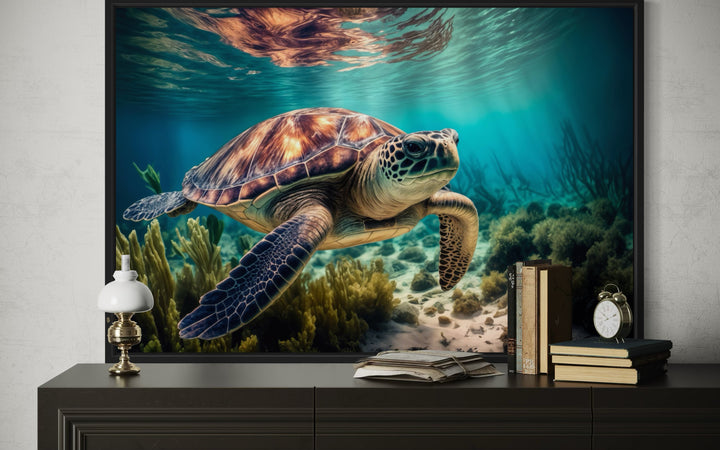 Sea turtle swimming over a coral reef in a framed canvas wall art displayed on a dark sideboard.