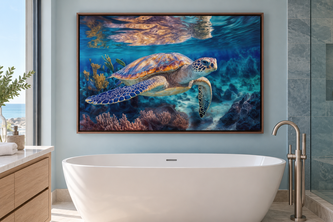 Sea turtle swimming near coral reef framed canvas wall art above a white bathtub in a bathroom.