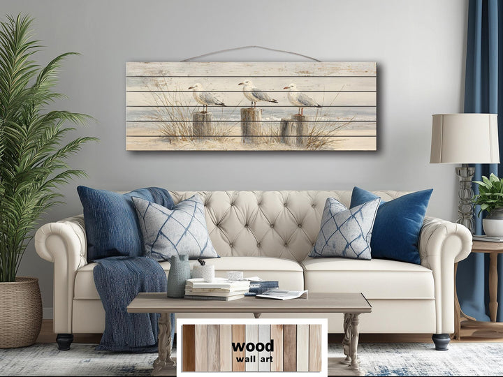 Large horizontal wood wall art featuring three seagulls on beach posts for coastal home decor.