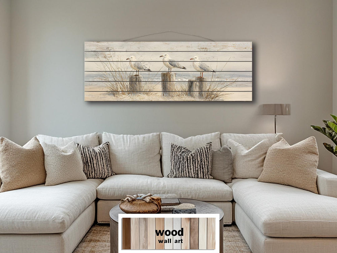 Large horizontal wood wall art featuring three seagulls on beach posts for coastal home decor.