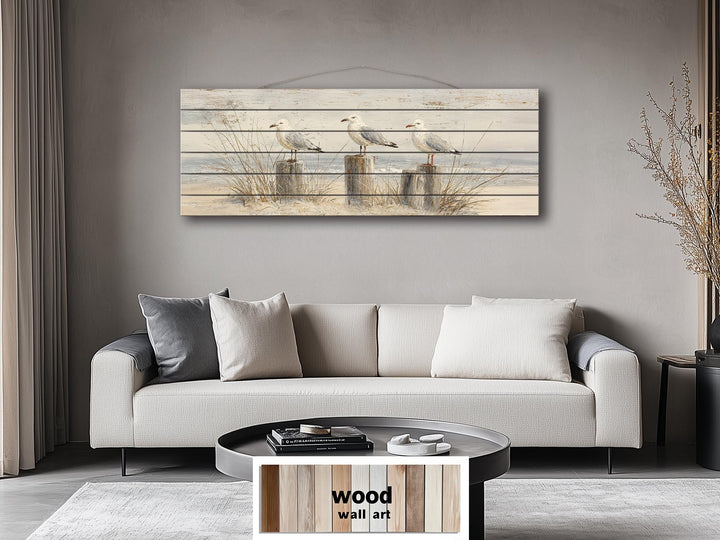 Large horizontal wood wall art featuring three seagulls on beach posts over a coastal scene.