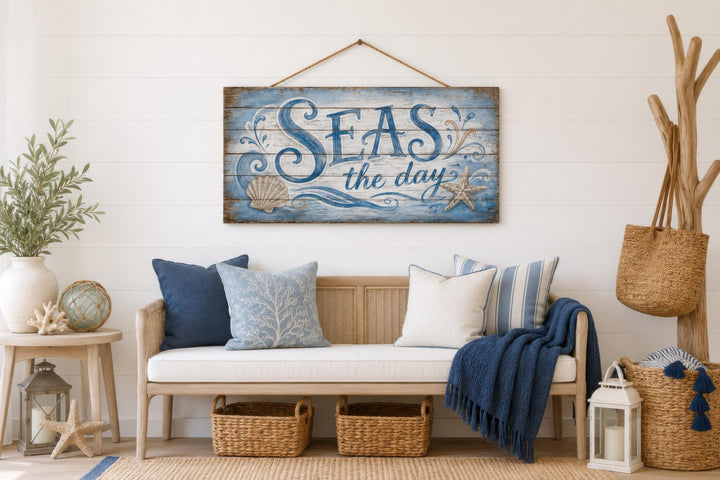 Seas The Day distressed wood wall art with coastal motifs hanging in a nautical-themed room.