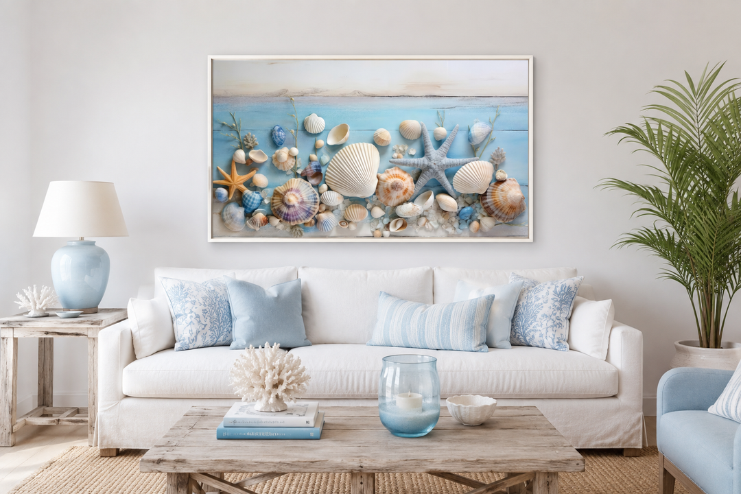 Seashells painting on blue wood coastal wall art displayed above a white sofa in a beach house.