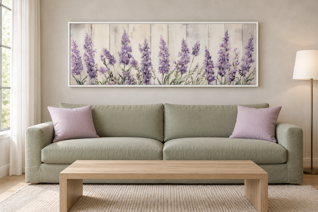 Purple lavender wildflowers framed canvas wall art hanging above a green sofa in a living room.