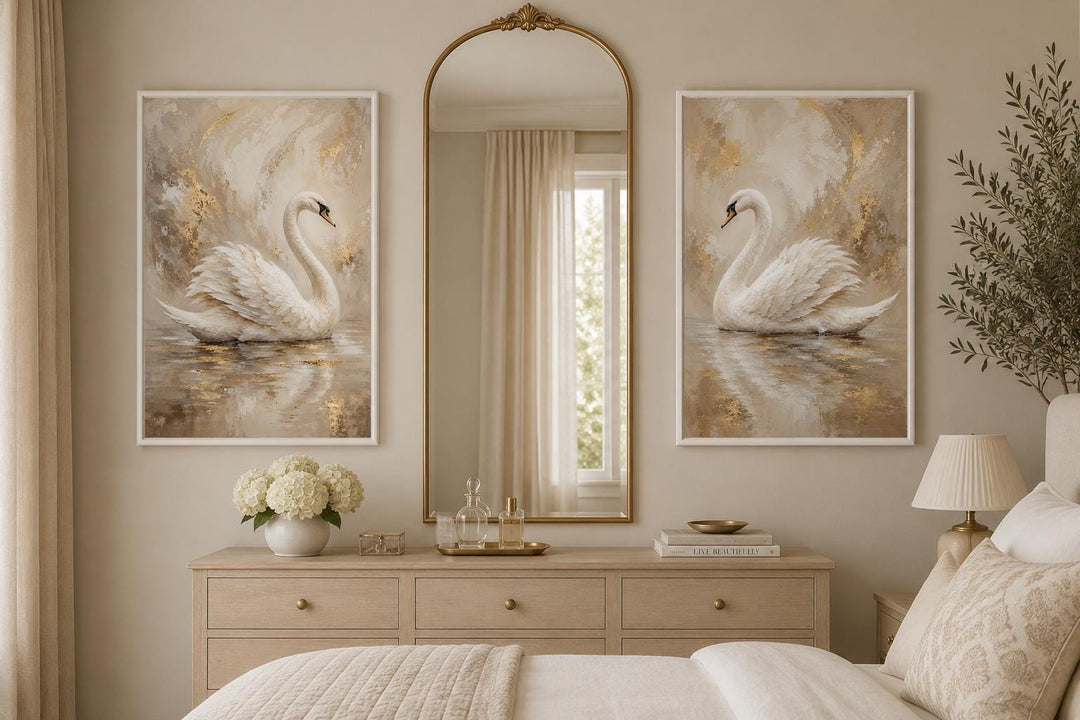 Set of 2 white swan canvas art prints with gold accents in a glam bedroom above a dresser.