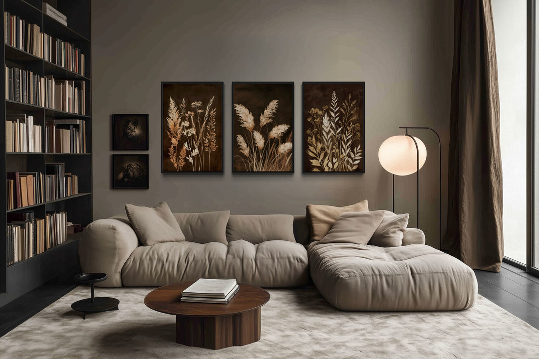 Set of 3 brown and beige boho grass canvas wall art prints displayed above a modern beige sofa.