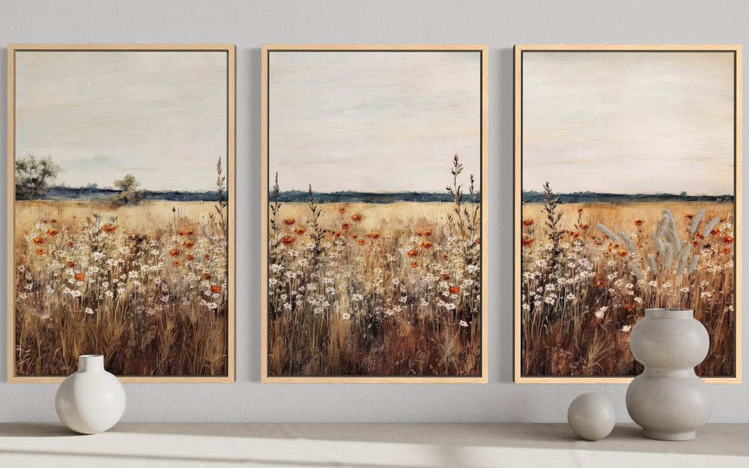 Set of 3 framed canvas prints featuring a rustic wildflower field in muted, earthy tones.