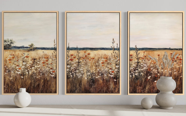 Set of 3 framed canvas prints featuring a rustic wildflower field in muted, earthy tones.