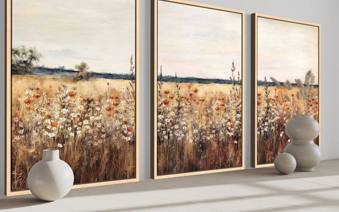 Set of 3 framed canvas prints featuring a rustic wildflower field in warm, earthy tones.