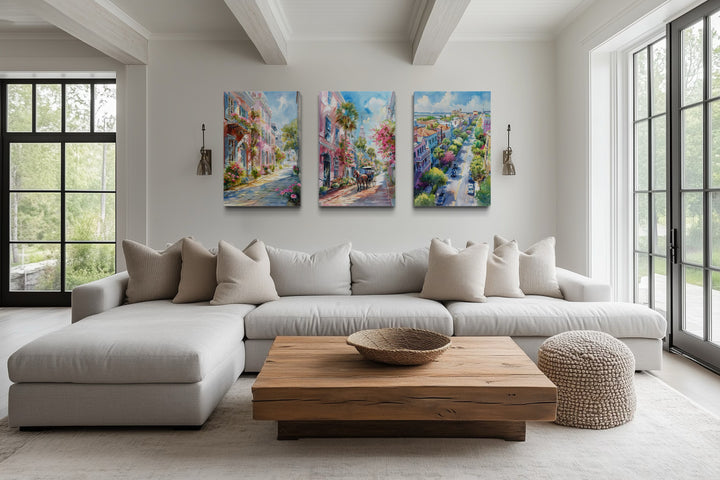 Set of three Charleston city watercolor framed canvas wall art pieces above a neutral sofa.