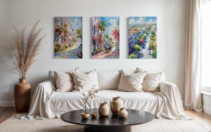 Set of three Charleston city watercolor framed canvas wall art pieces above a white sofa.
