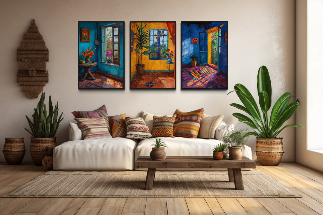 Set of three framed canvas prints featuring vibrant Mexican interior scenes above a white sofa.