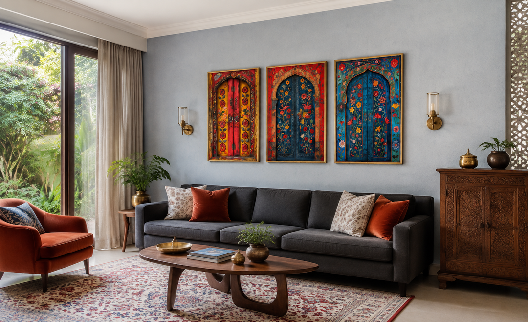Set of three Madhubani style Indian door paintings on canvas displayed above a dark grey sofa.