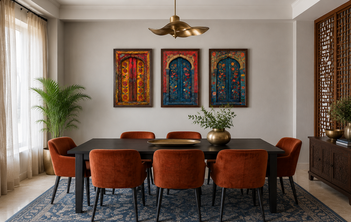 Set of three Madhubani door paintings on canvas, framed and hung above a dining table.