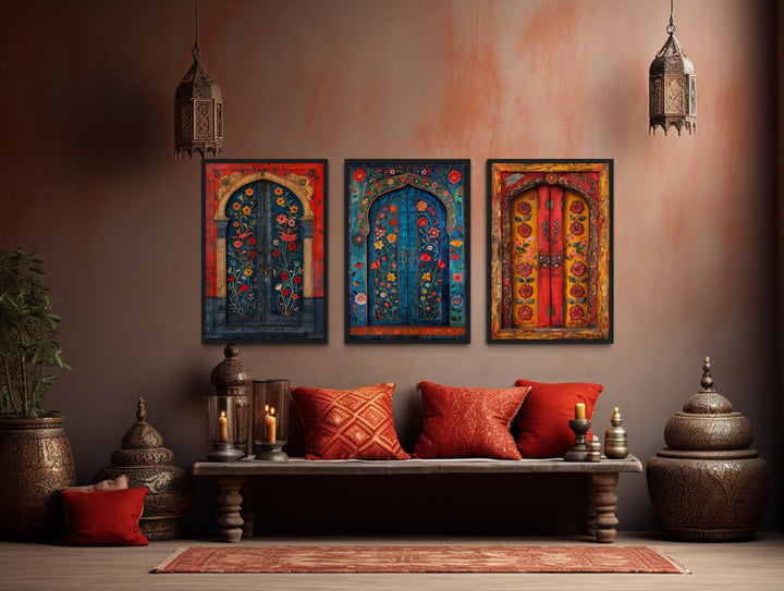 Set of three Madhubani door paintings on canvas displayed above a bench in a bohemian living room.