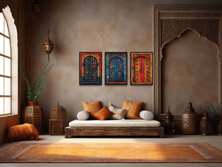 Set of three Madhubani door paintings on canvas displayed above a daybed in a bohemian living room.