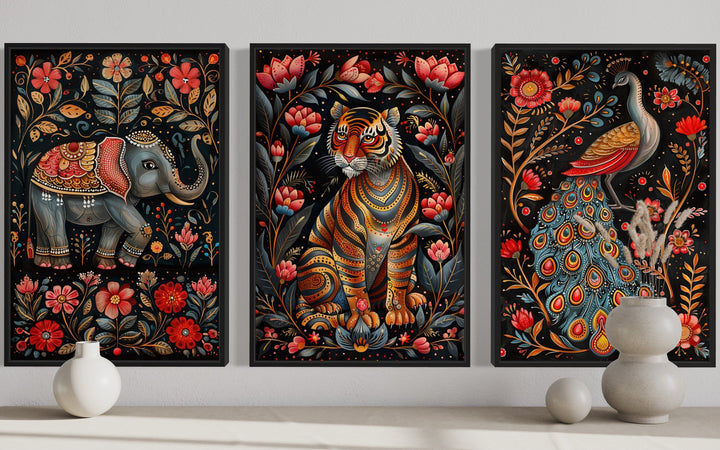 Set of three Madhubani style framed canvas wall art featuring a tiger, elephant, and peacock.