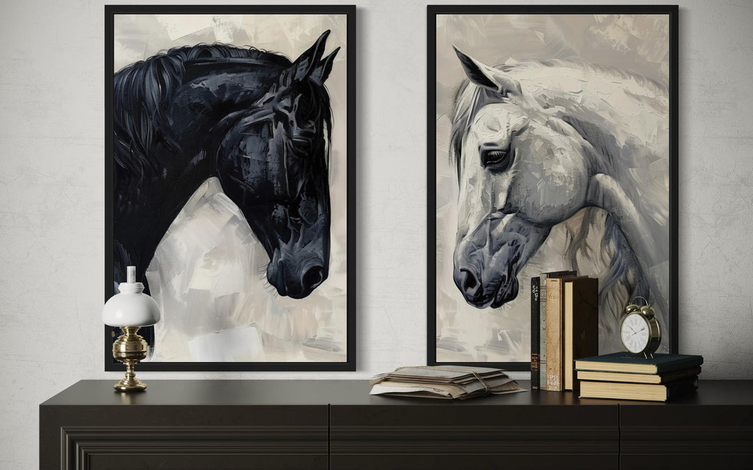 Set of 2 framed canvas wall art featuring black and white horse portraits on a dark console table.