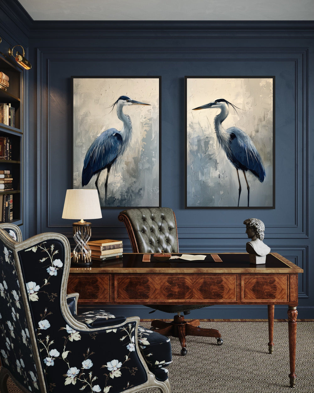 Set of 2 framed canvas prints featuring abstract blue herons on a dark blue paneled wall.