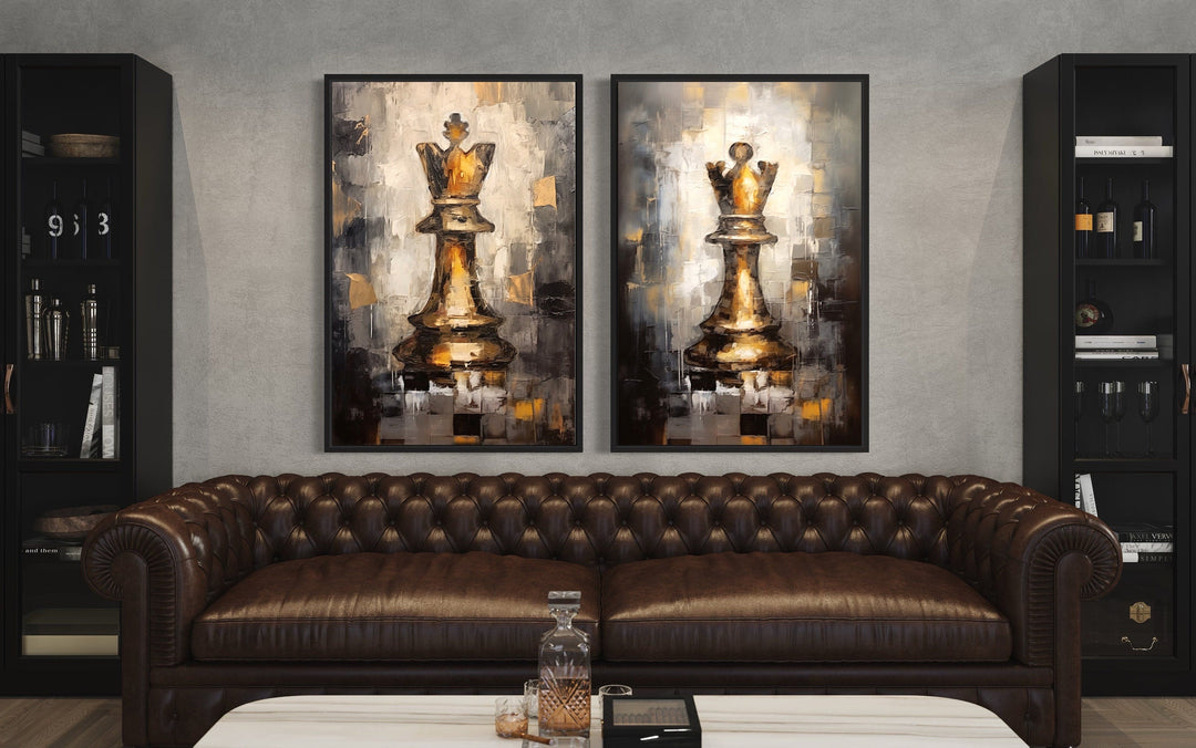 Set of 2 framed canvas wall art featuring golden chess king and queen pieces over a brown sofa.