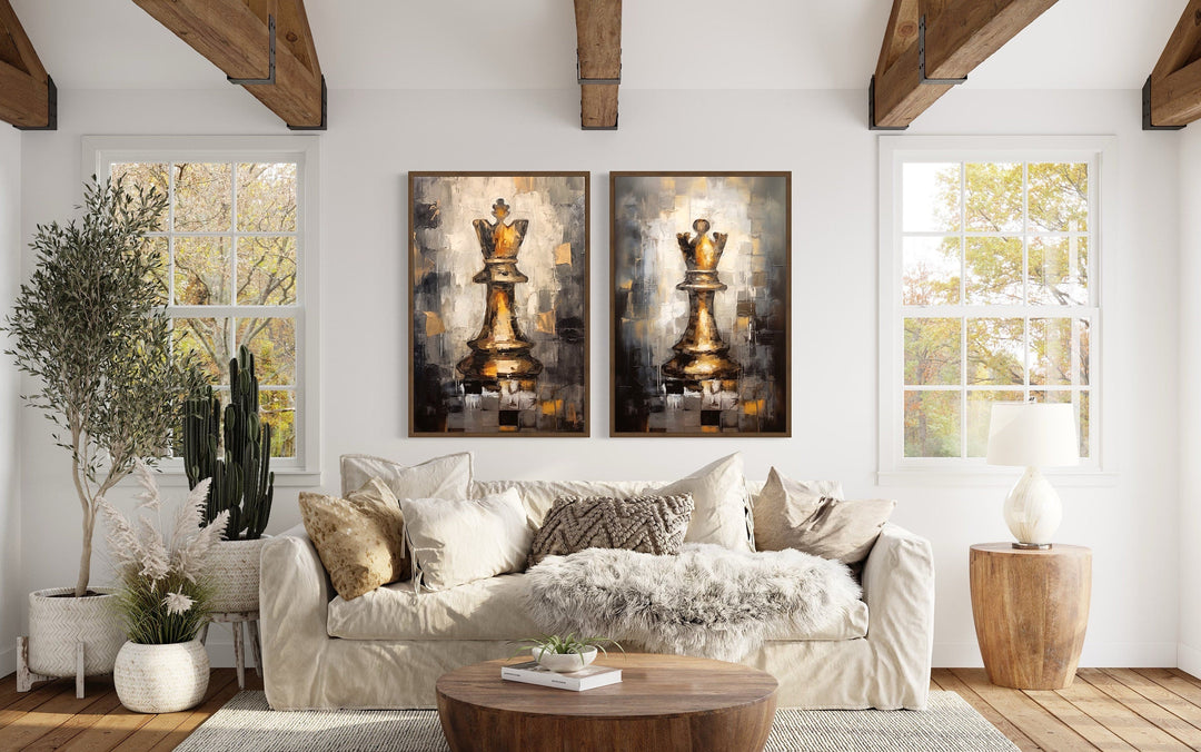 Set of 2 framed canvas wall art featuring golden chess king and queen pieces above a beige sofa.