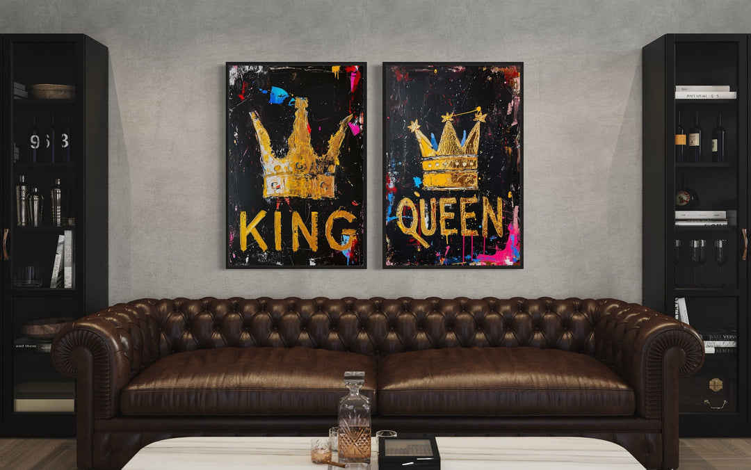 Set of 2 King and Queen crown pop art framed canvas prints above a brown leather sofa.