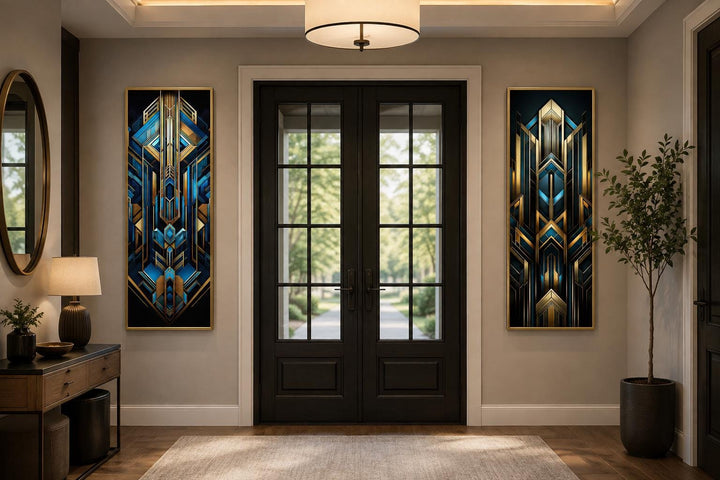 Set of 2 tall vertical Art Deco geometric canvas panels in navy blue and gold flanking a dark door.