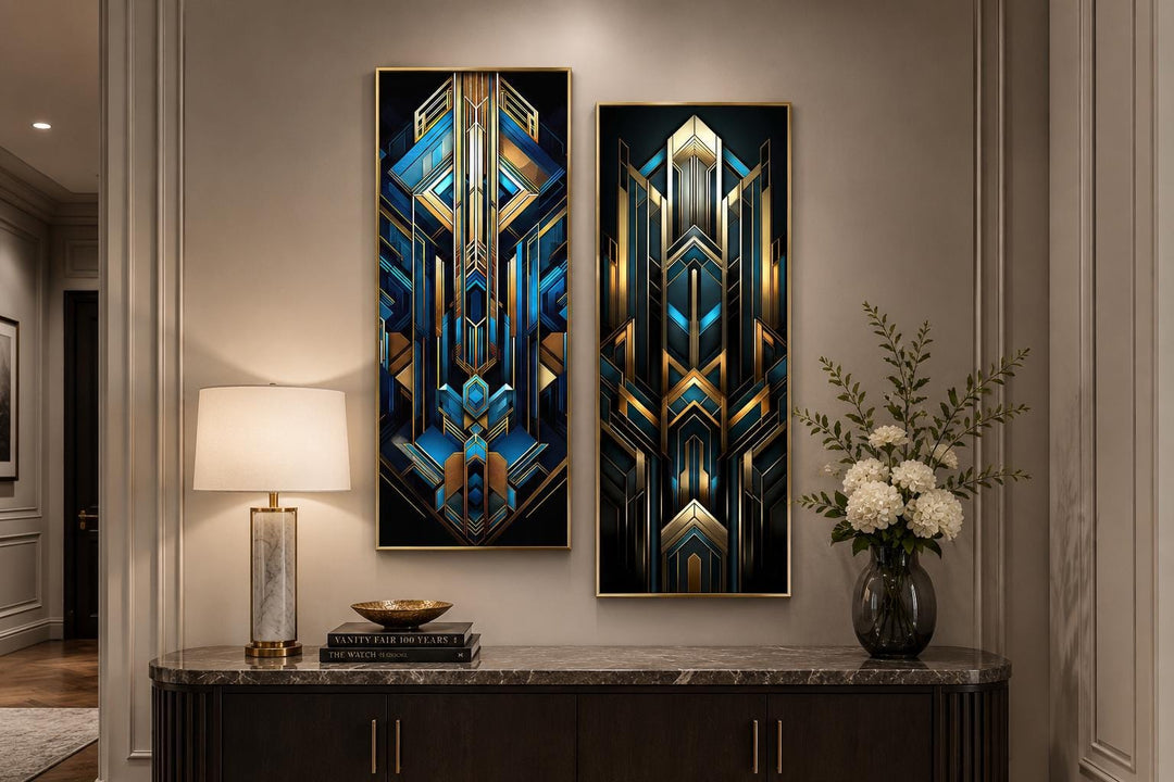 Set of 2 tall vertical Art Deco geometric canvas panels in navy blue and gold on a console table.