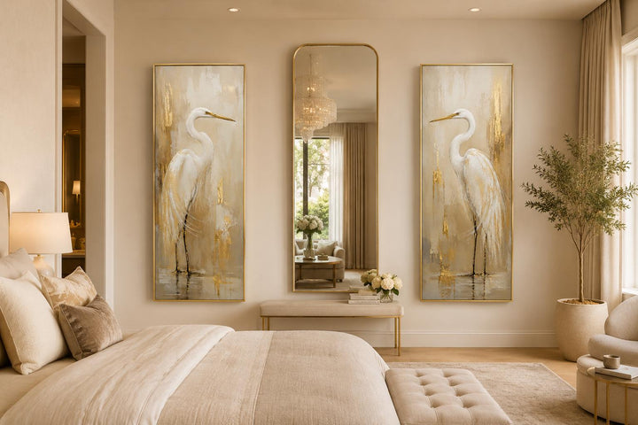 Set of 2 tall narrow canvas prints featuring white egrets with gold accents flanking a wall mirror.