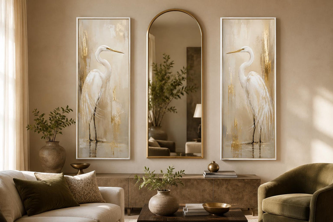 Set of 2 tall narrow canvas prints featuring white egrets with gold accents flanking an arch mirror.