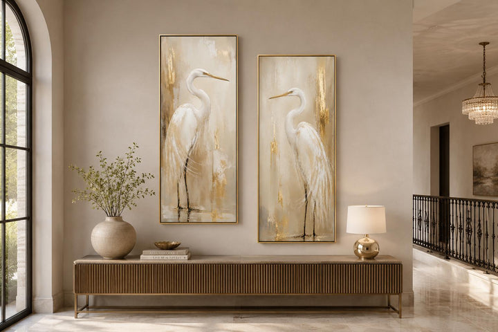 Set of 2 tall narrow canvas prints featuring white egrets with gold accents in a modern entryway.