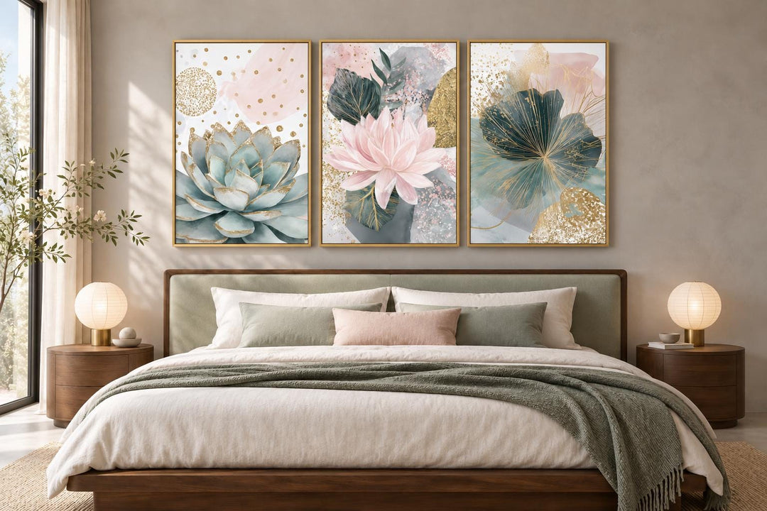 Set of 3 framed canvas prints featuring blush pink and teal succulent floral designs above a bed.