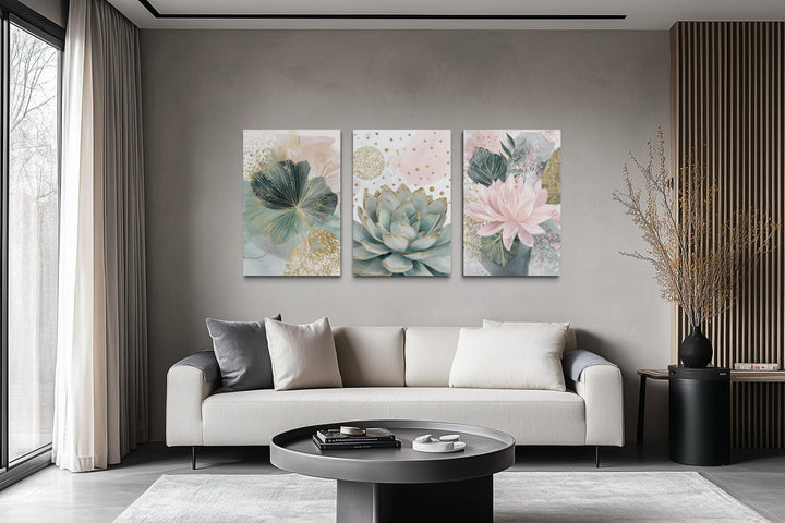 Set of 3 blush pink and teal succulent floral framed canvas prints hanging above a modern sofa.