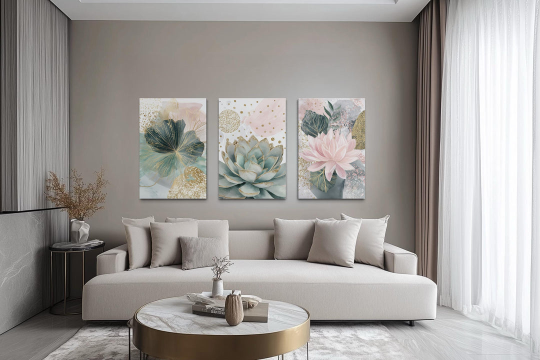 Set of 3 blush pink and teal succulent floral framed canvas wall art hung above a beige sofa.
