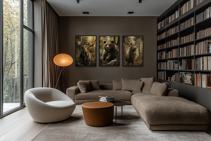 Set of 3 framed canvas paintings featuring a moose, bear, and elk in a forest setting.
